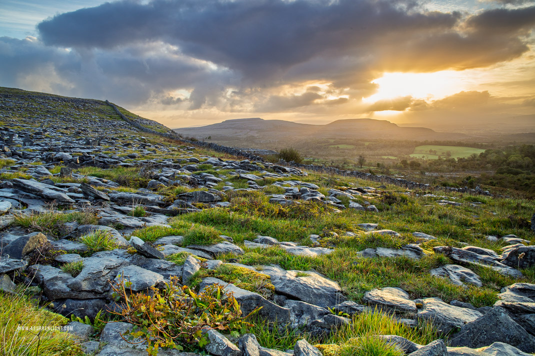 Sunrise over limestone pavement and distant hills